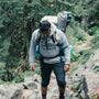 person hiking up a hill with a backpack on