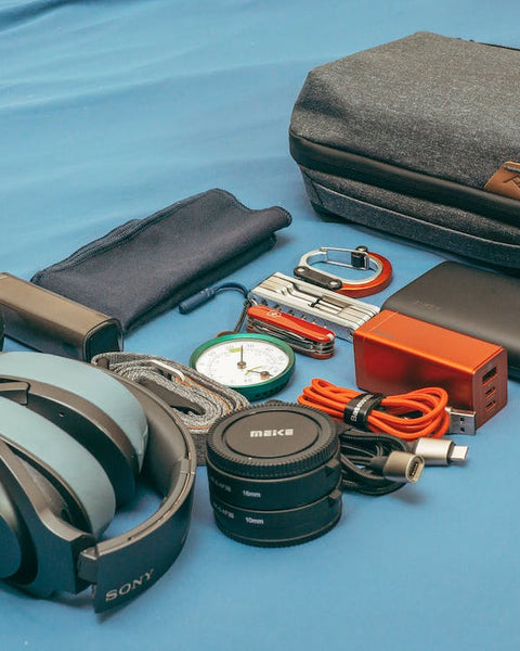hiking accessories laid out on a blue mat